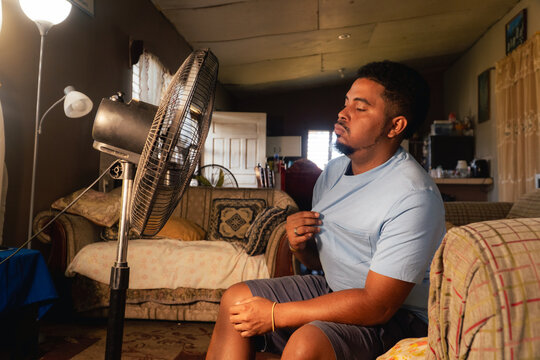 Man finding relief from summer heat at home