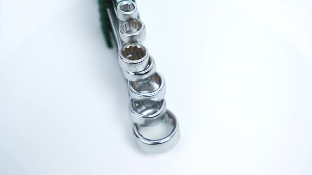A rotating stack of combination wrenches displays size progression and uniform finish. Ideal for illustrating professional workshop tools and reliability.