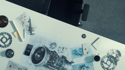 Top down aerial view of engineer hold tablet while learning about engine. Aerial view of skilled...