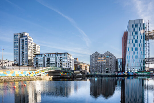 View of the Grand Canal with redeveloped high‑rise buildings and the historic Bolands Mills complex, blending old and new in the Docklands, Dublin, Ireland.