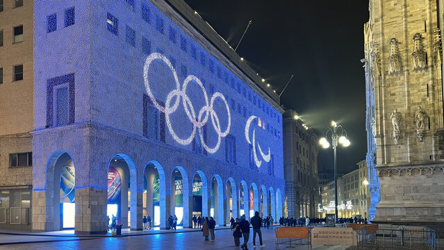 Milan, Italy &ndash; January 31, 2026: Olympic rings and Paralympic symbol illuminated on historic building at Piazza Duomo ahead of Milano Cortina 2026 Winter Games