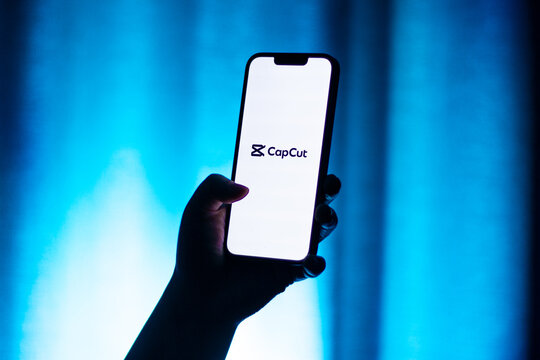Kaliningrad, Russia - 12.11.2025. Smartphone screen in woman hands displaying logotype of popular application for video editing CapCut. Video edit app