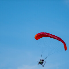 Paramotor Makes A Banking Turn Against Blue Sky
