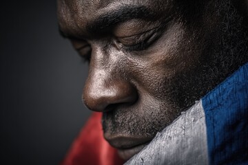Obraz premium Emotional Close-Up Portrait of Man Holding Tricolor Flag with Eyes Closed