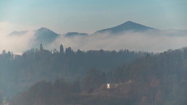 Ljubljana Slovenia time lapse city skyline at Virgin Mary's Visitation Church and Alps mountain range