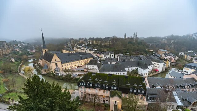 Grand Duchy of Luxembourg time lapse city skyline and fog haze at Grund along Alzette river in the historical old town