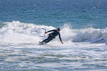 kitesurfer riding his board on the sea	