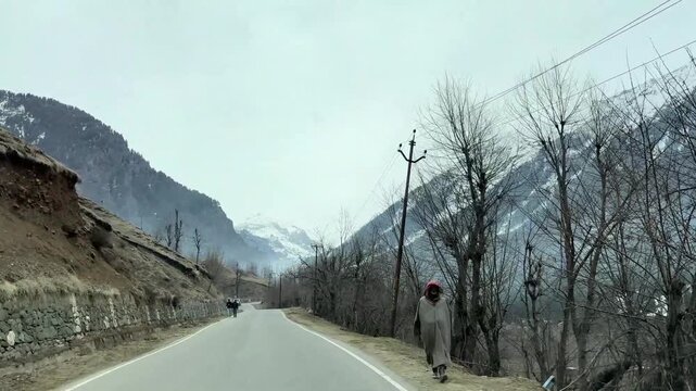 Scenic road and pathway leading to Chandanwari Valley winding through mountains, rocky terrain, and natural landscapes near Pahalgam, Kashmir.