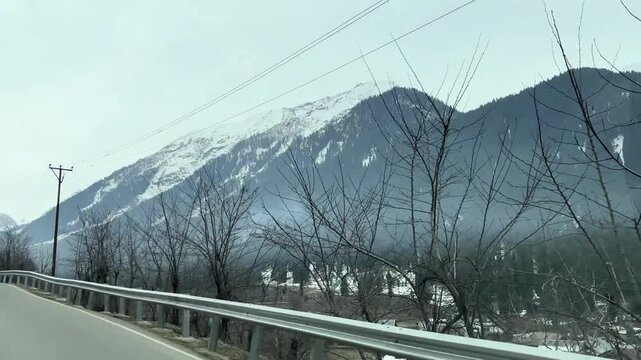 Scenic road and pathway leading to Chandanwari Valley winding through mountains, rocky terrain, and natural landscapes near Pahalgam, Kashmir.