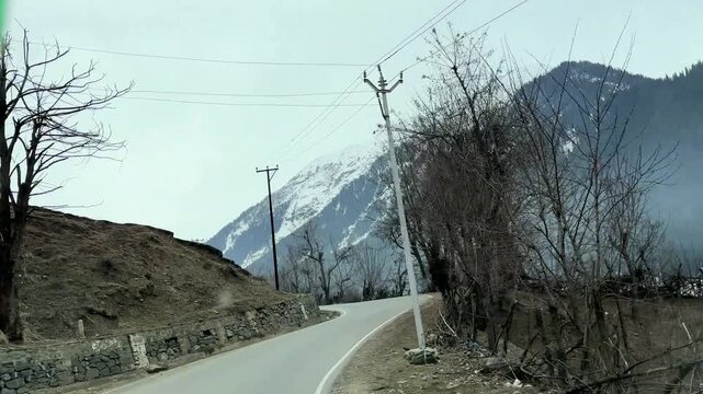 Scenic road and pathway leading to Chandanwari Valley winding through mountains, rocky terrain, and natural landscapes near Pahalgam, Kashmir.