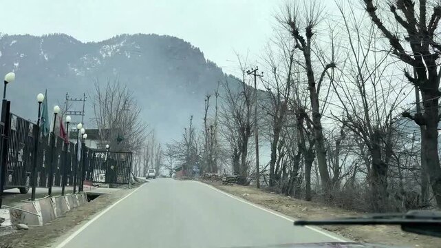 Scenic road and pathway leading to Chandanwari Valley winding through mountains, rocky terrain, and natural landscapes near Pahalgam, Kashmir.