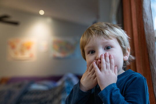 Toddler boy staring at camera with a runny nose