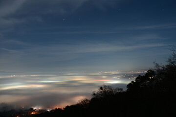 Fototapeta premium city light shinning through the night fog