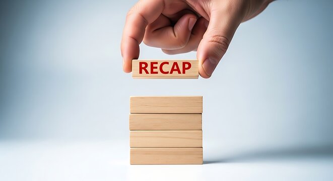Hand placing wooden block with red text R E C A P on stack of blocks recap summary review conclusion