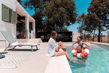 Family enjoying summer vacation day by swimming pool © PintoArt