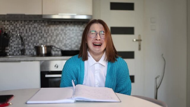 Young woman tears letter written to parents crying in emotional breakdown releasing long held resentment through painful psychological self healing moment