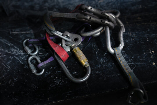 Concept of adventure, sport, and outdoor activity. Metal pitons and carabiners used in rock climbing and mountaineering.