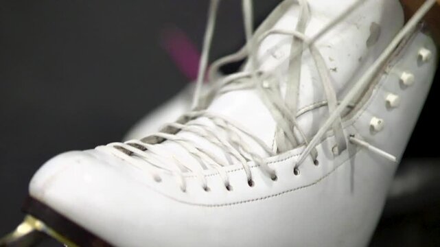 Close up of woman tying ice skates
