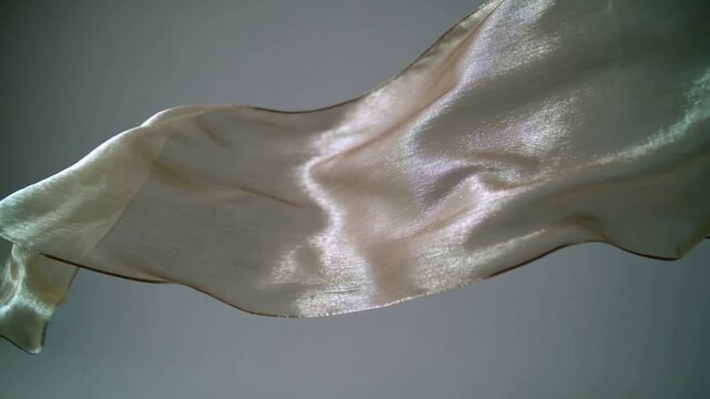 Iridescent silk fabric flowing in slow motion