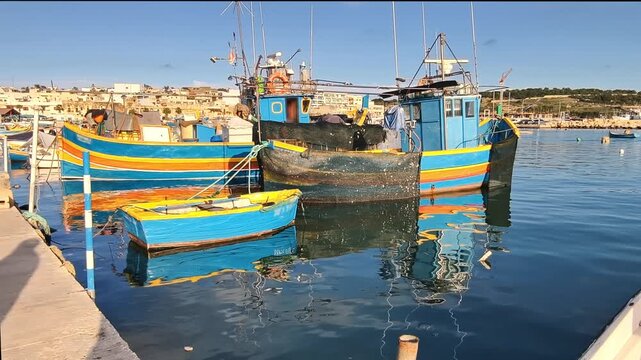 Marsaxlokk, Malta &ndash; Traditional fishing village with colorful boats and historic buildings at the sunny harbor. Shows authentic island life and maritime culture in Malta