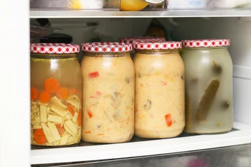Fototapete Zu Essen Homemade preserved soups in glass jars. Chicken broth and Thai soup stored on fridge shelf. Traditional pickled cucumbers in brine. Home food preservation. Ready meals prepared in advance.  © Paweł Michałowski