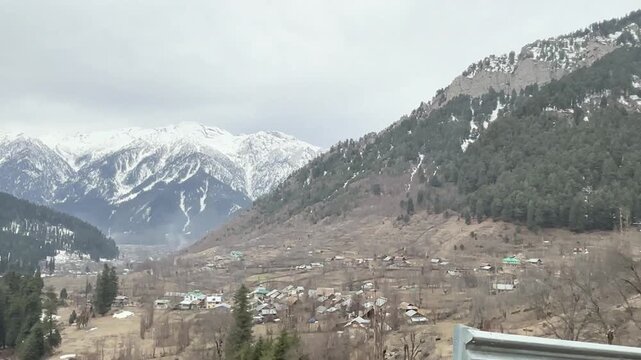 Scenic pathway leading to Betaab Valley surrounded by lush green meadows, pine forests, flowing streams, and Himalayan mountains in Pahalgam, Kashmir.