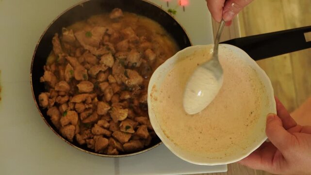 Top view - preparation of chicken pieces in a frying pan
