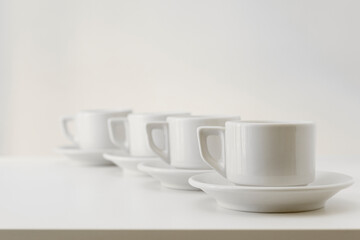Four white cups on table