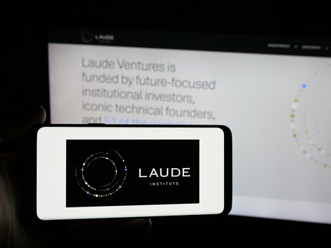 Stuttgart, Germany - 01-30-2026: Person holding smartphone with logo of computer science organisation Laude Institute on screen in front of website. Focus on phone display.
