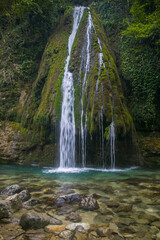 a beautiful waterfall in the mountains