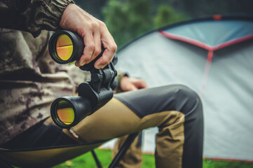Naklejka premium Binoculars by a Tent in Nature