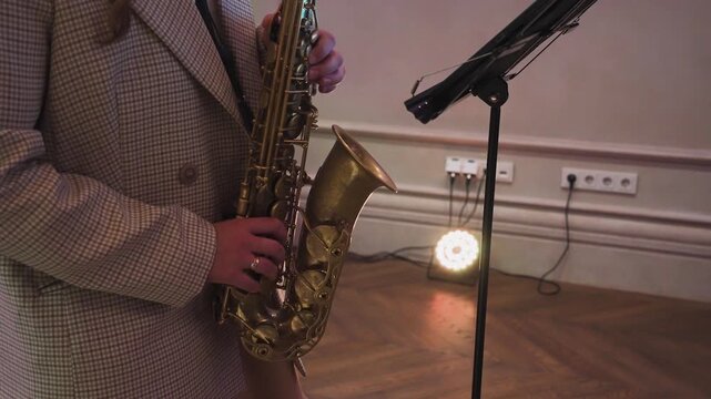 A woman plays the saxophone at a celebration