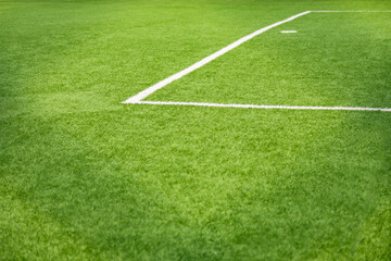 Obraz premium Close-up of white markings on the green grass of a soccer field&nbsp;