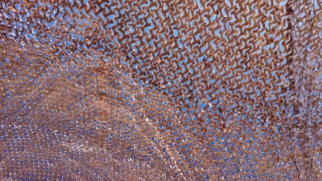 Mesh Net Flying in the Wind Against Blue Summer Sky Texture Background
