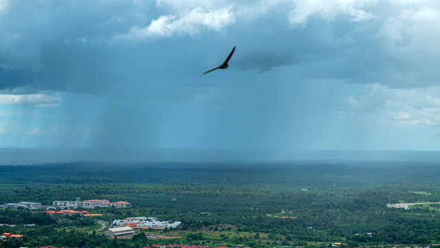 Monsoon season in the tropics. Thunderstorm, a tropical downpour over the equatorial rain forest of Borneo Island. Malaysia, city