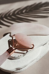 Fototapeta premium Rose quartz facial roller and gua sha stone for skincare and beauty treatments