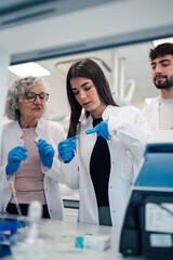 Scientists working together in modern medical laboratory