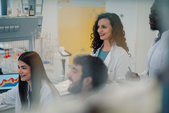 Diverse students collaborating during scientific experiment in modern laboratory