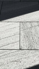 Textured Pavement With Dramatic Shadow Patterns And Sunlight