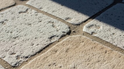 Obraz premium Textured Paving Stones In Sunlight With Deep Shadows