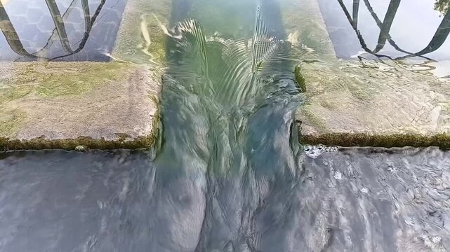Clarified Water Flowing Out And Exiting The Sedimentation Tank At An Industrial Water Treatment Plant