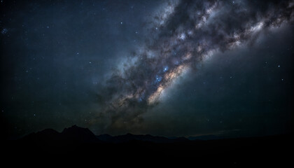 Fototapeta premium Night nature landscape - view of the starry sky with the Milky Way in the mountains. Created using generative AI tools