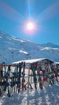 ski rack in snow against sunny mountain peak at ski resort
