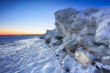 Fototapeta premium Ice toros on the Baltic Sea beach in Mikoszewo at sunrise. Poland