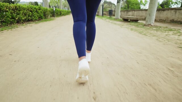 Woman running in park slow motion montage