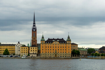 Fototapeta premium Riddarholmen Church and Historic Palaces in Stockholm Sweden Featuring Iconic Gothic Spire and Waterfront Architecture over Riddarfjärden