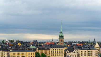 Stockholm Skyline Featuring Gamla Stan Old Town and Tyska Kyrkan Spire Panoramic View of Historic Swedish Architecture under Dramatic Overcast Sky