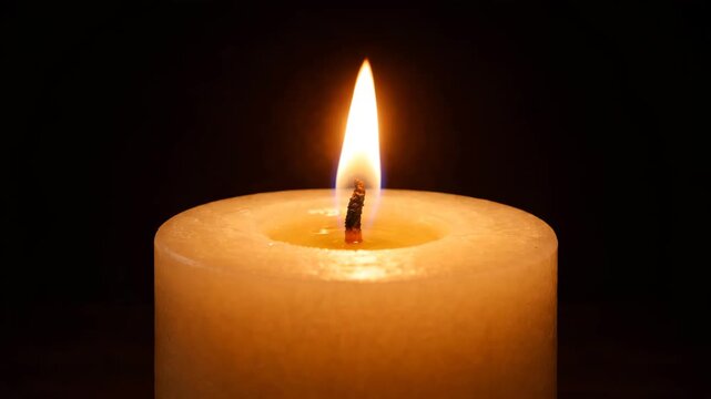 Single Candle Glowing Quietly in the Dark