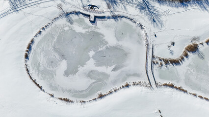 pond lake frozen snow covered water ice background from the air aerial 