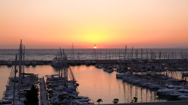 Wide panoramic sunset view of the modern kusdasi marina filled with yachts and sailboats on the aegean coast, Kusadasi, Aydin, Turkey